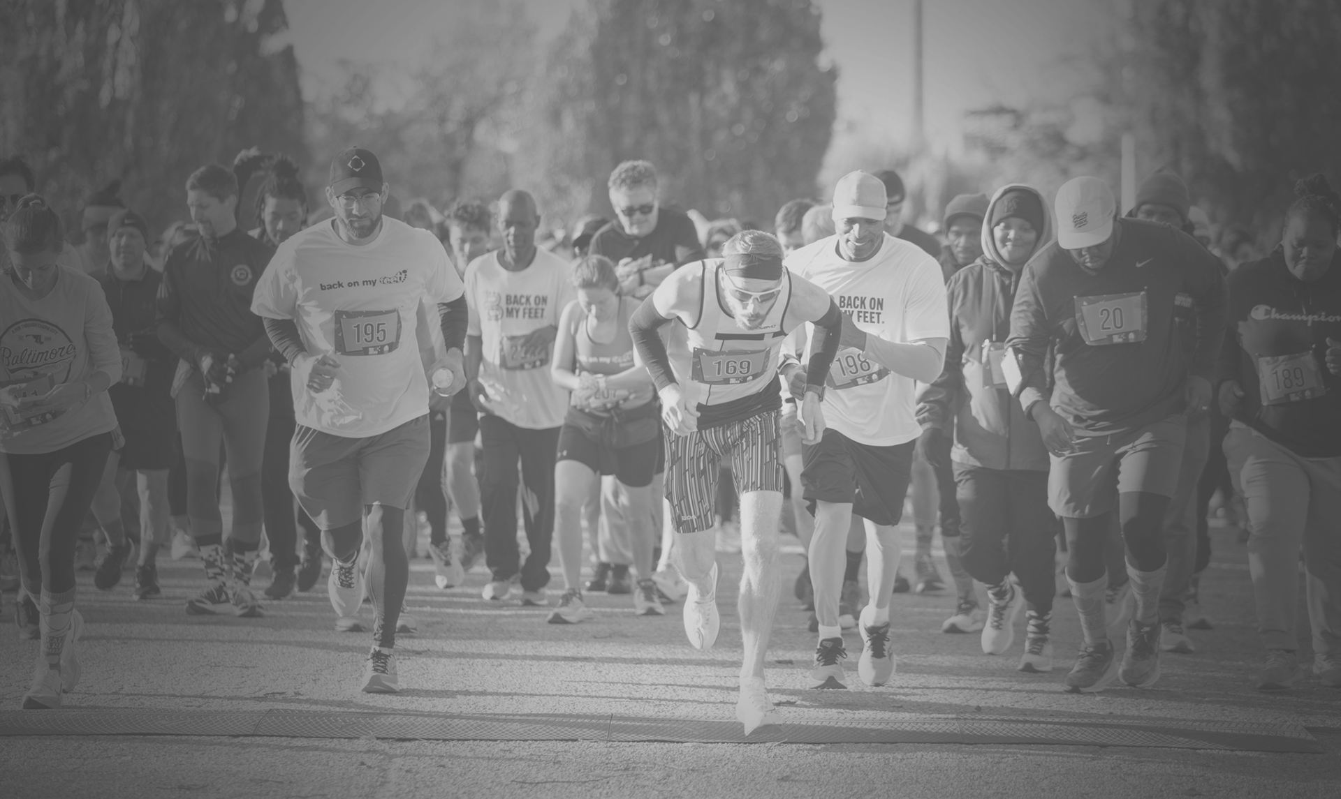 A black and white photo of runners