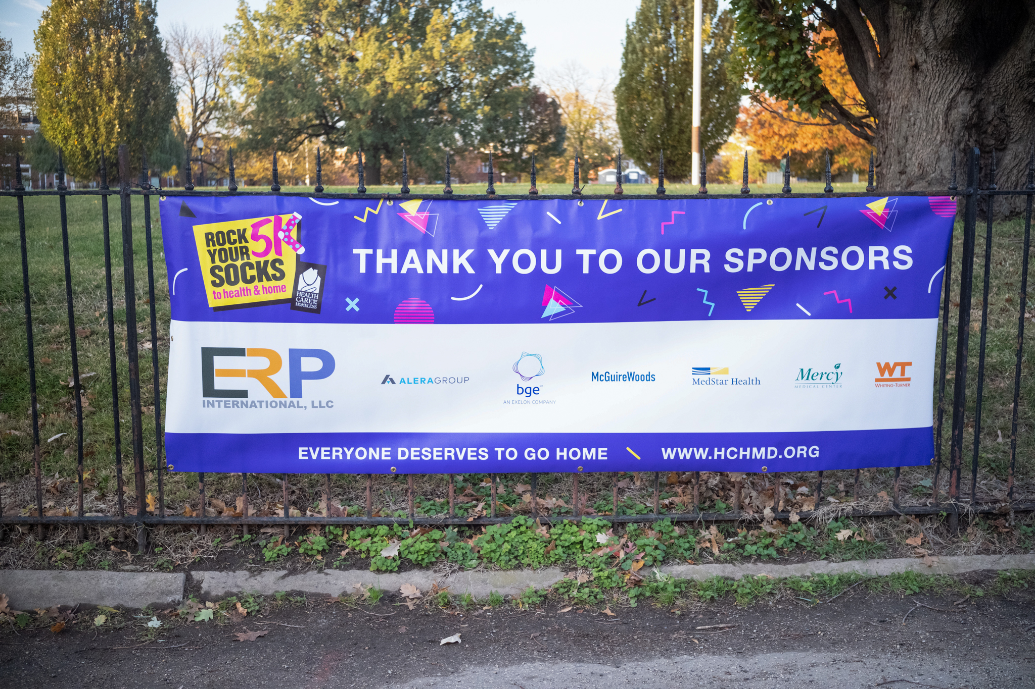 A sign lists the event sponsors