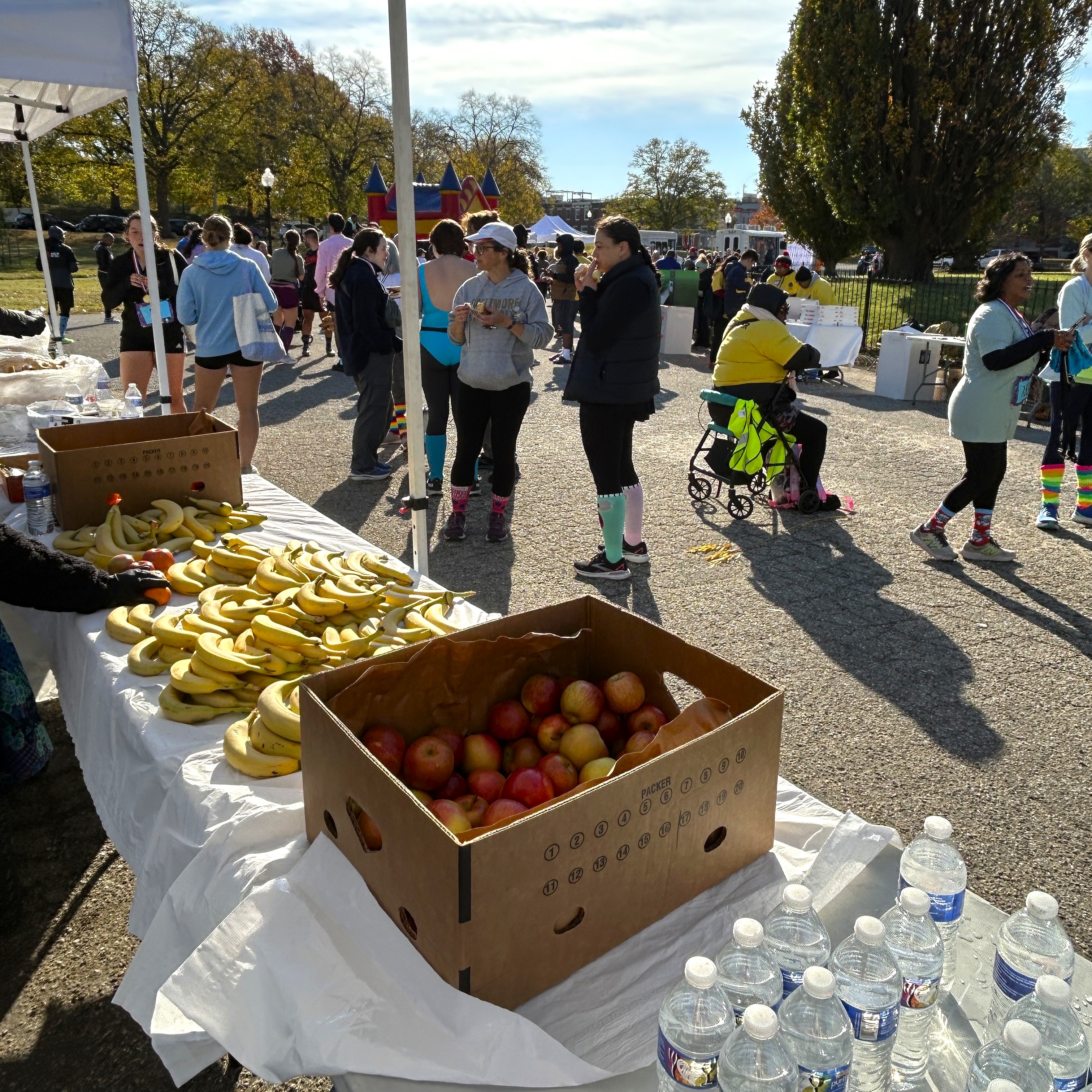 Apples, water bottles and bananas on a table
