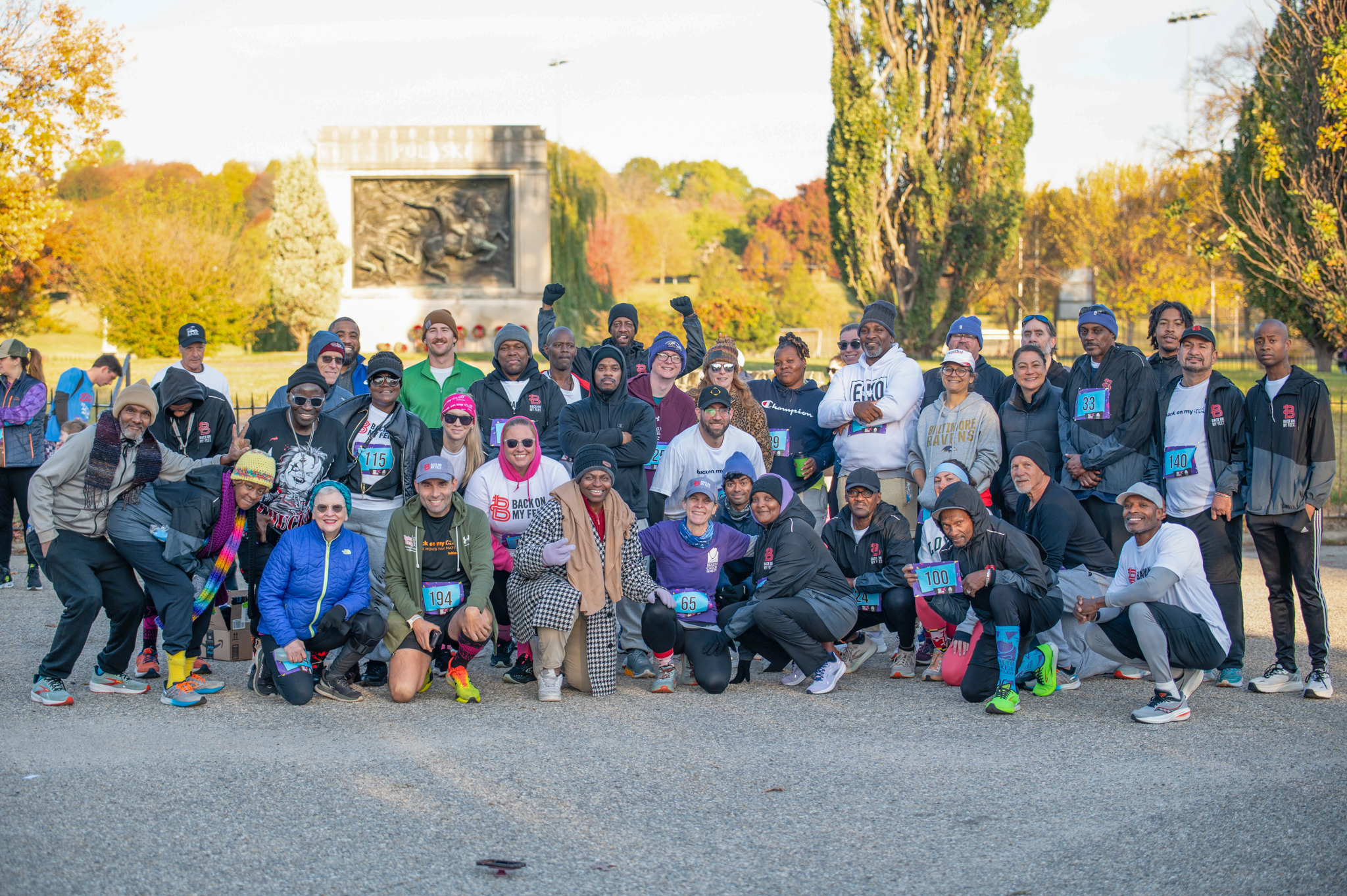A large group of 5K participants pose for a group photo.