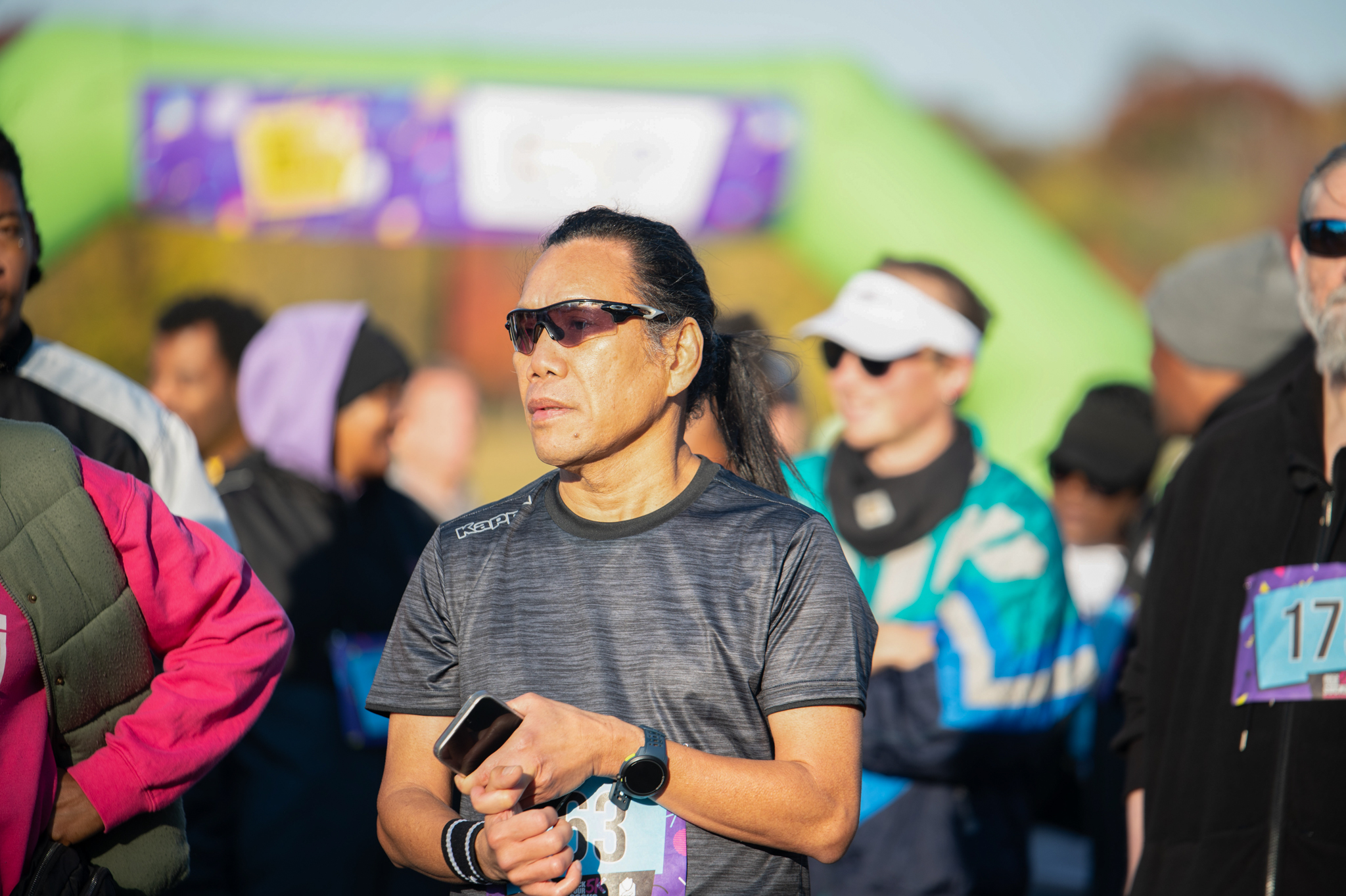 A medium-skinned man in a grey t-shirt and sunglasses
