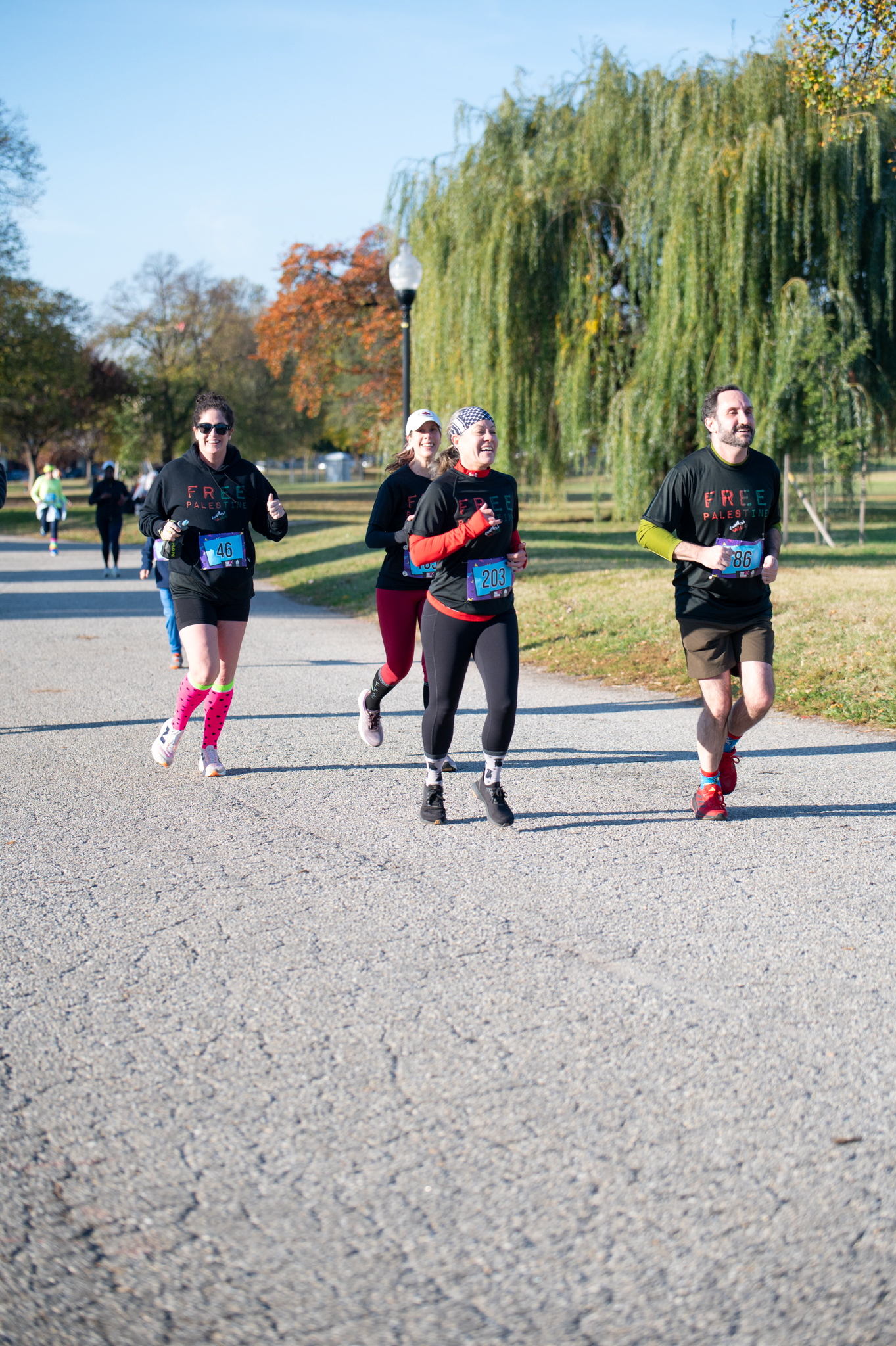 5K runners wearing black shirts jog 