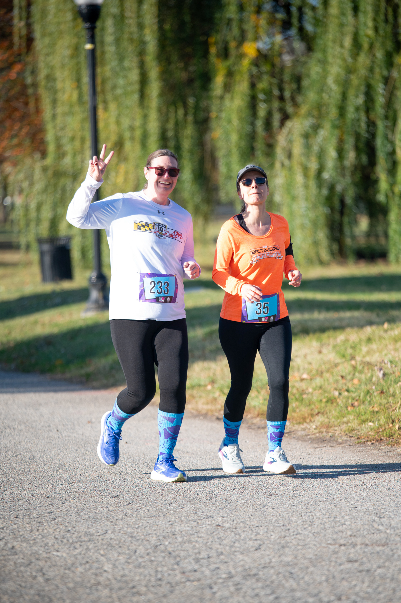 Two light-skinned women jog
