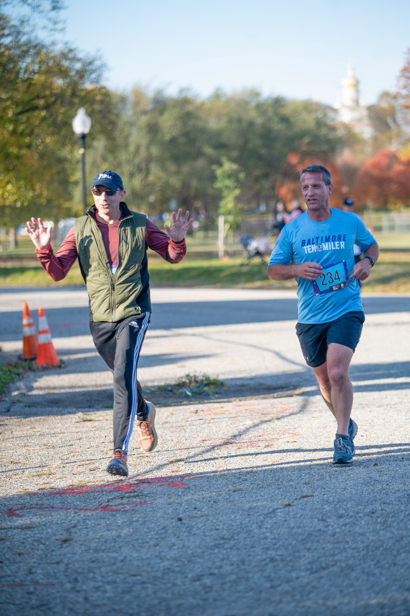 Two light-skinned men approach the finish line
