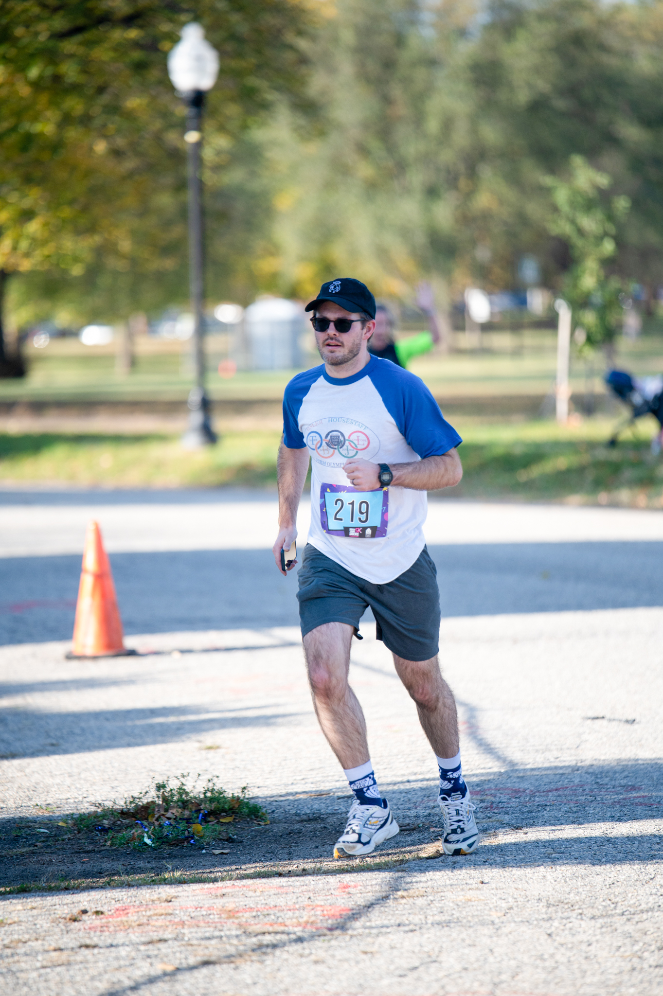 A light-skinned man in a blue and white top jogs