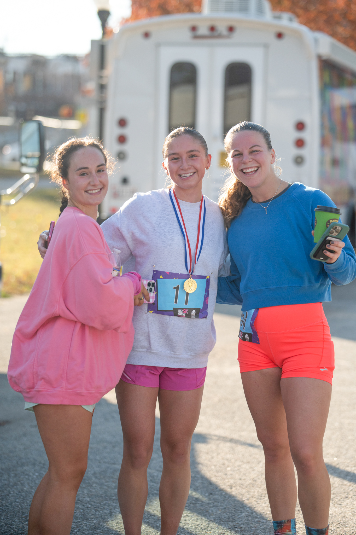 A group of three light-skinned woman smiling