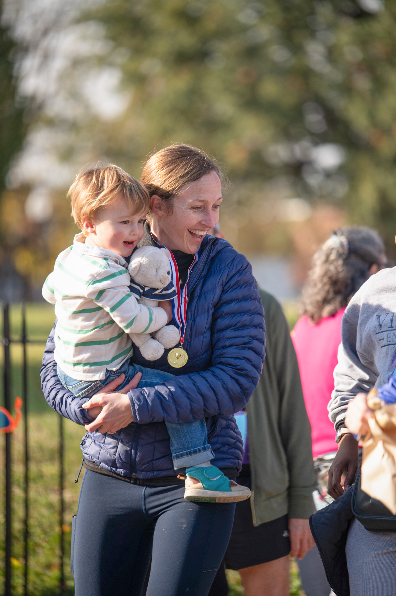 A light-skinned woman holds a light-skinned child