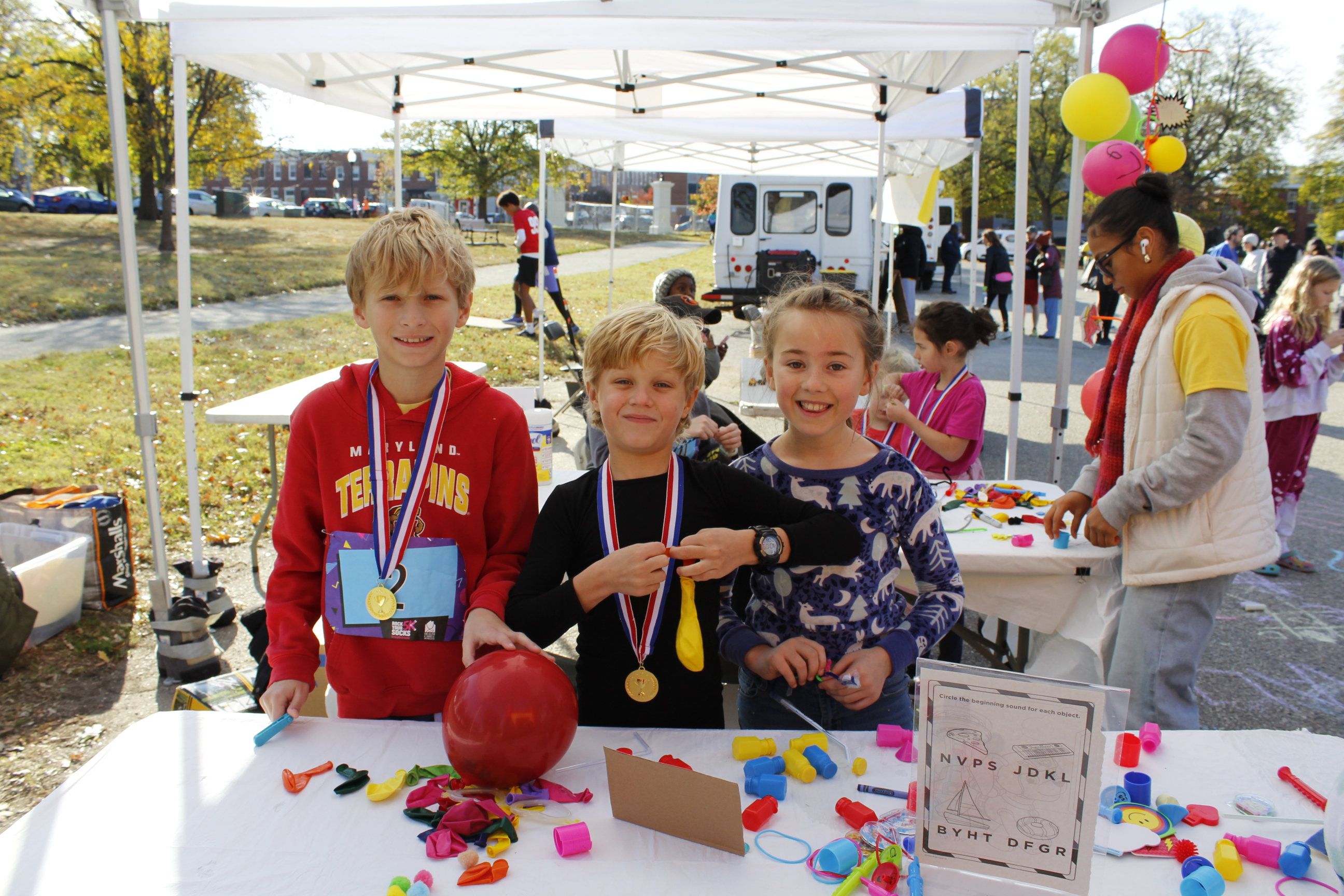 The light-skinned kids at smiles while playing at the craft table.