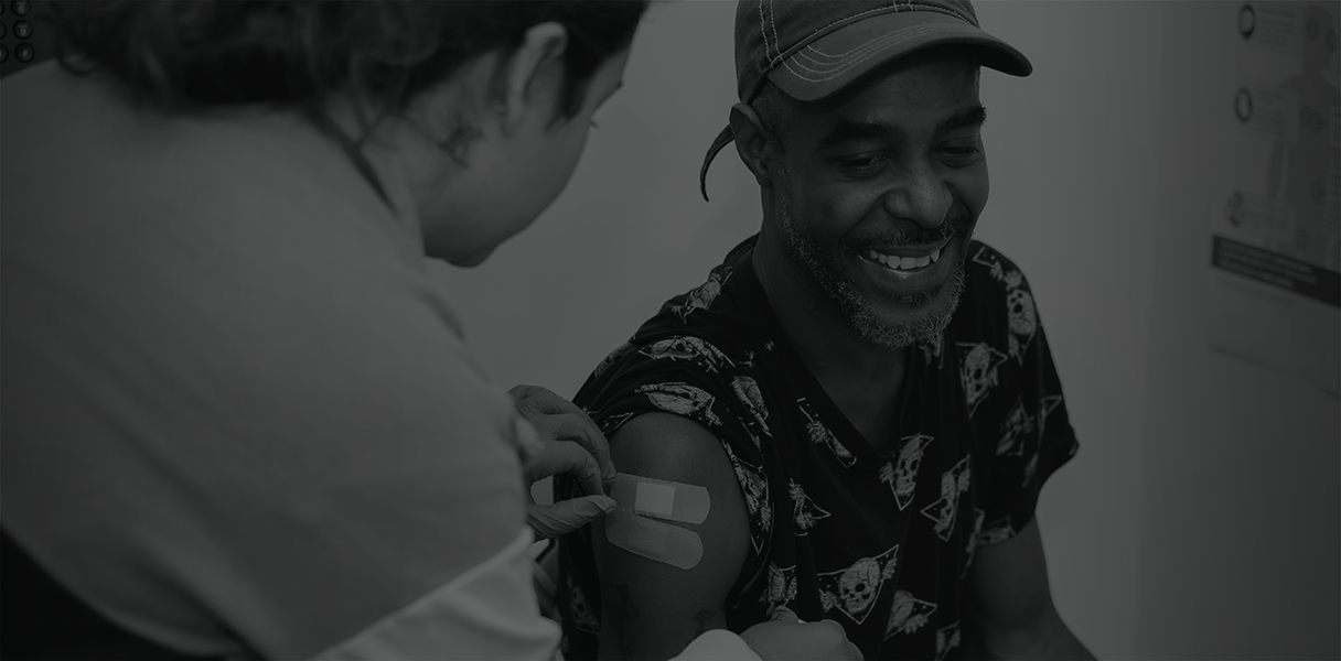 Black and white photo of a man receiving a flu shot