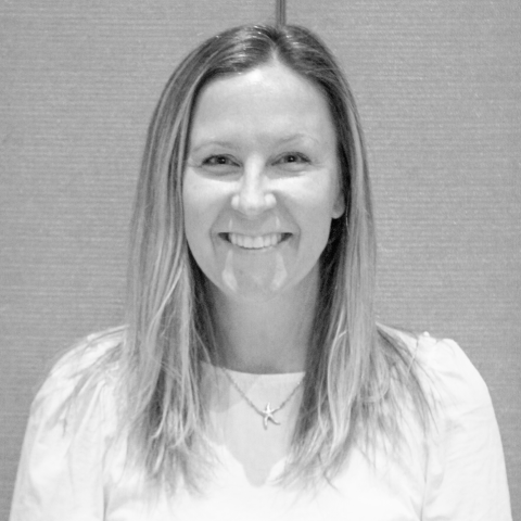 A black and white headshot of a light-skinned woman with long light-colored hair.