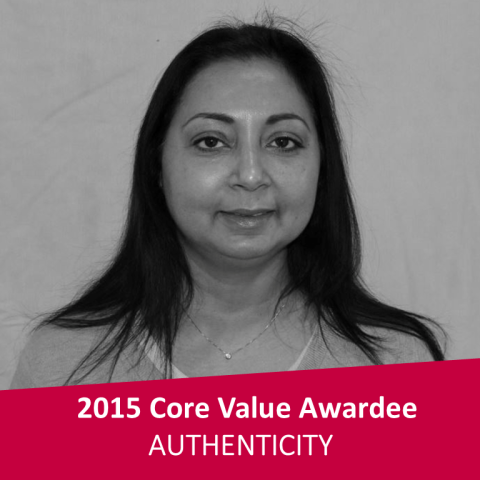 A black and white headshot of a medium-skinned woman with long dark hair