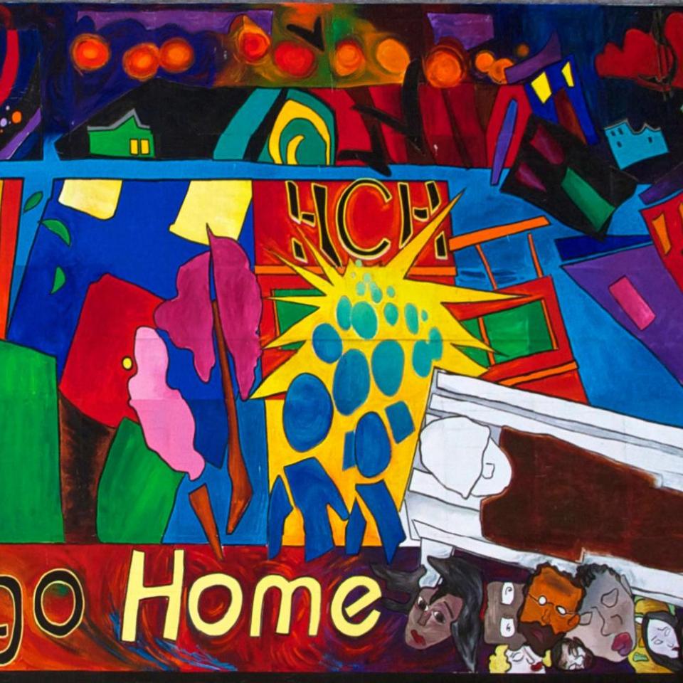 Colorful mural that reads "Everyone Deserves to Go Home"