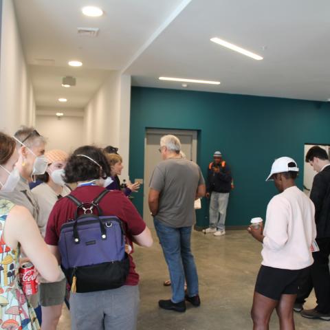 A group of visitors waiting to tour Sojourner Place at Oliver