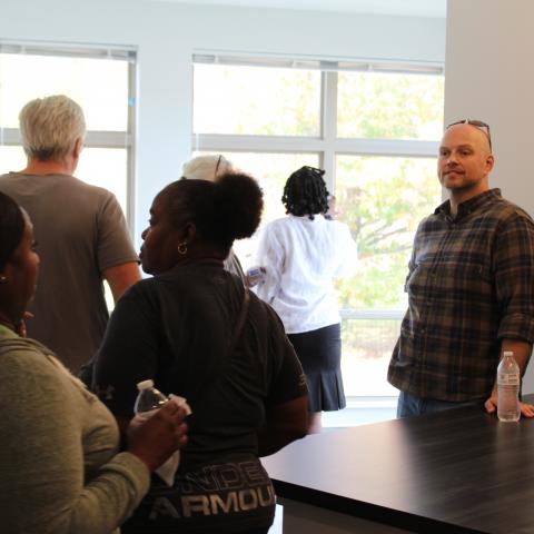 Sr. Director of Development Kevin Feldt guides visitors through a tour of SPO apartments. 